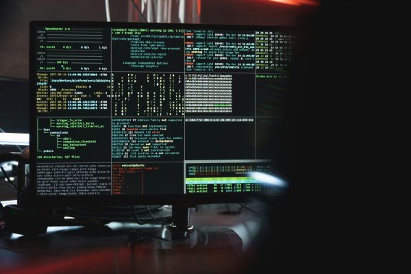 pexels-photo-5380664-5380664 Close-up of a computer monitor displaying cyber security data and code, indicative of system hacking or programming.