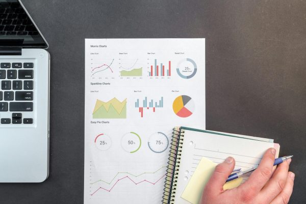 pexels-photo-669610-669610 Overhead view of a business desk with charts and a laptop, ideal for data analysis concepts.